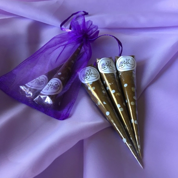 Henna Lines branded henna cones over purple mesh sheet