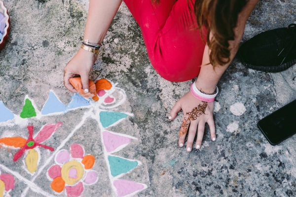 lady with hand on floor with henna design