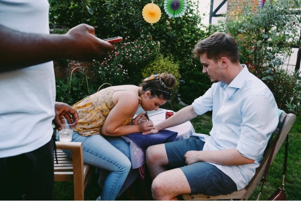 Henna artist painting henna on mans arm